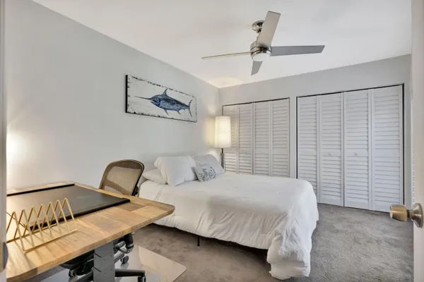 a bedroom with a bed and a table in it