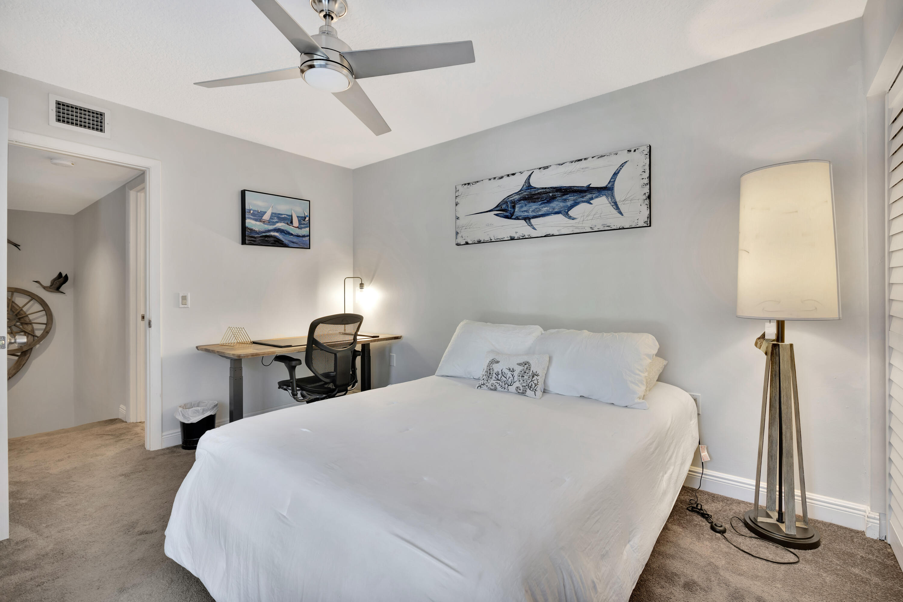 1209 12th Court Jupiter, FL 33477 - Photo 18 of 31 a bedroom with a bed and a lamp