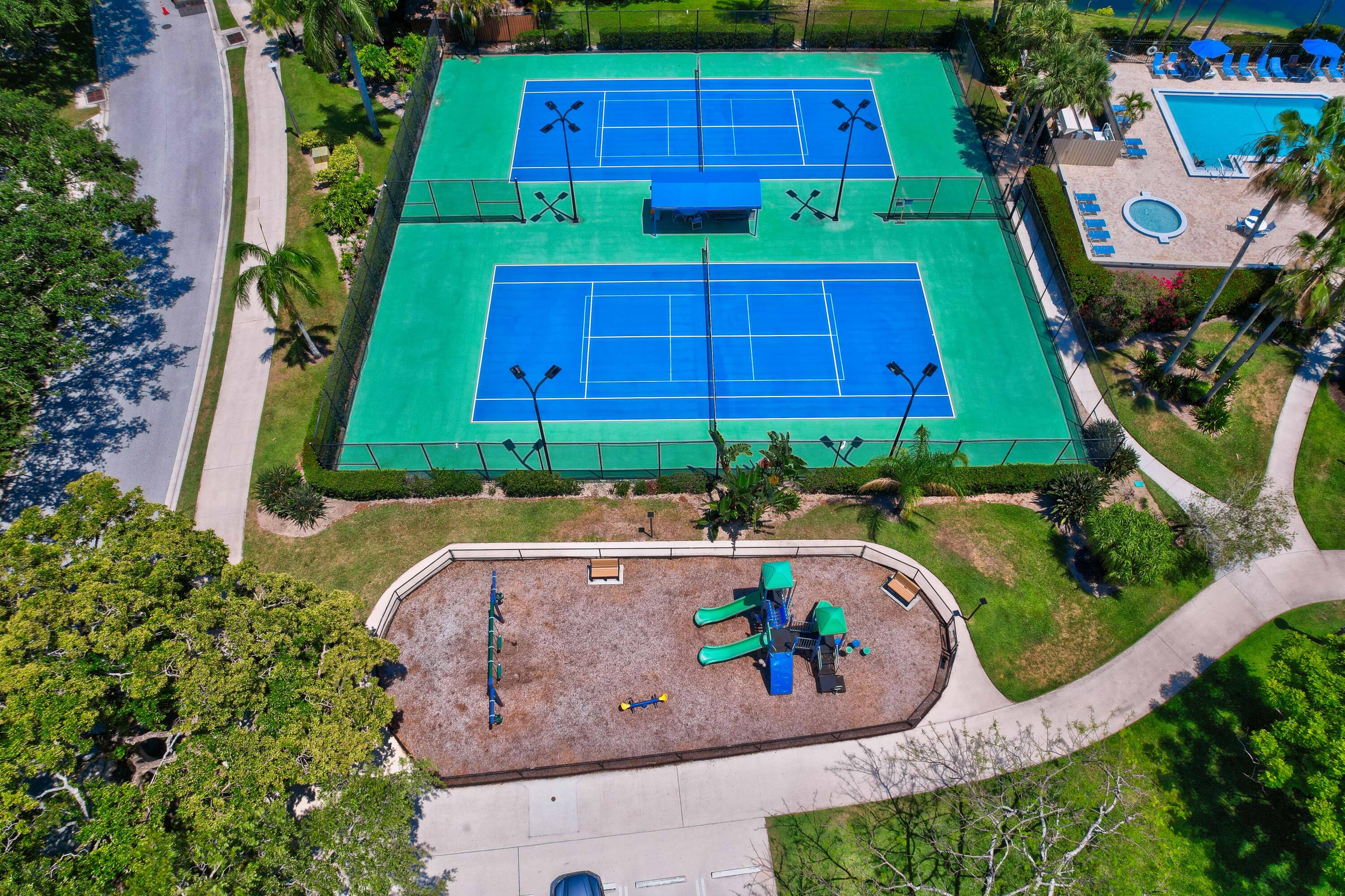 1209 12th Court Jupiter, FL 33477 - Photo 30 of 31 an outdoor view with swimming pool and outdoor seating