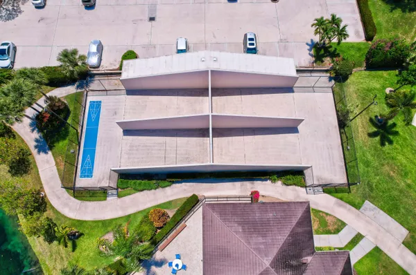 an aerial view of a multi story residential apartment building with a yard