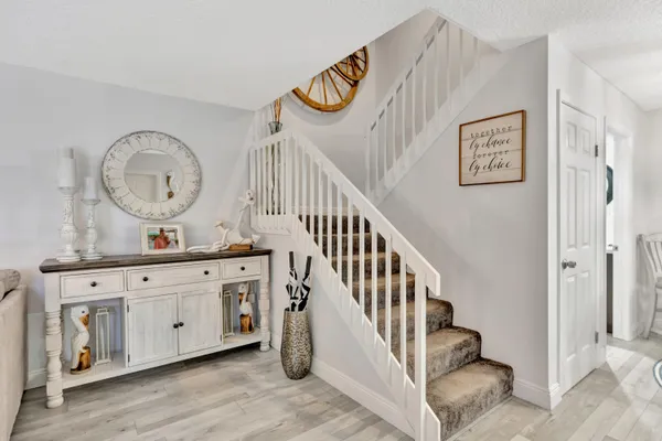 a view of an entryway with wooden floor