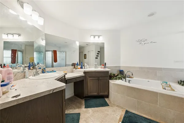 a view of a bathroom with a sink and mirror with bathtub