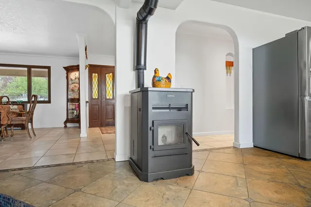 a kitchen with a refrigerator and table chair
