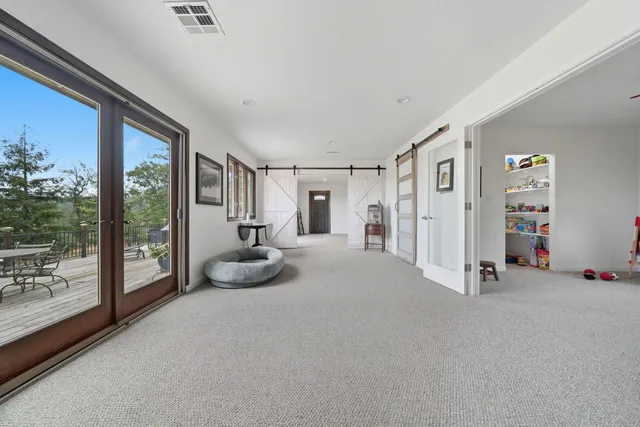 a room with furniture and large windows