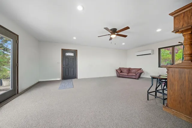 a view of a livingroom with furniture and a ceiling fan
