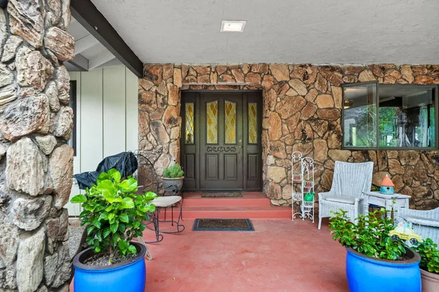 a front view of a house with potted plants