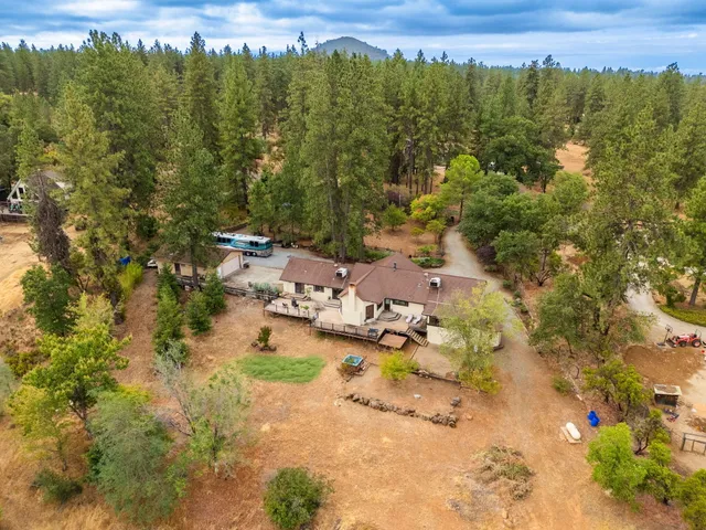 an aerial view of a houses with a yard