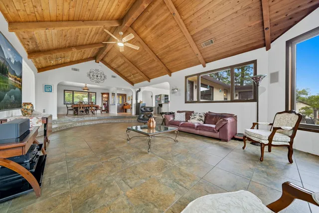 a living room with furniture gym equipment and a chandelier