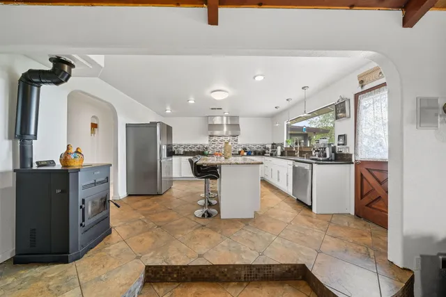 a kitchen with a refrigerator and a sink