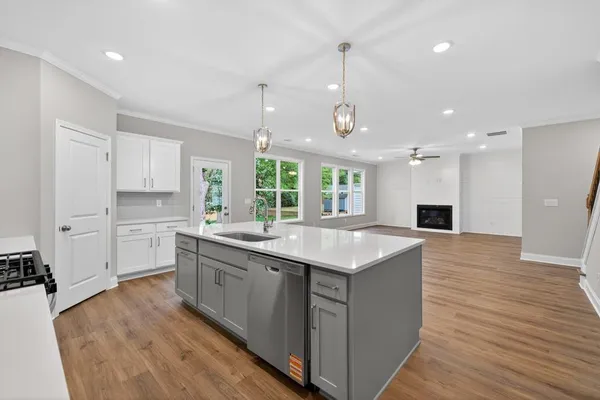 a kitchen with a sink window and cabinets