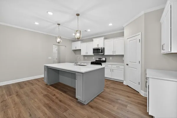 a kitchen with kitchen island white cabinets and white appliances
