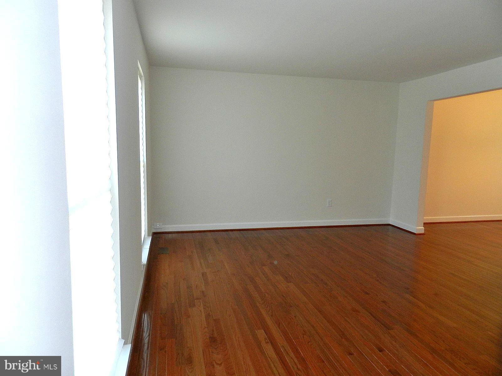 932 Pointer Ridge Drive Gaithersburg, MD 20878 - Photo 6 of 29 a view of an empty room with wooden floor and a window