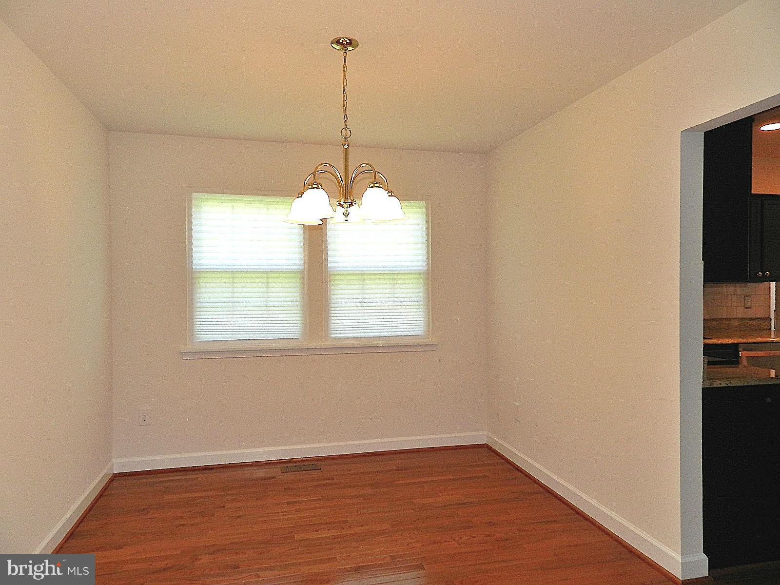 932 Pointer Ridge Drive Gaithersburg, MD 20878 - Photo 7 of 29 a view of an empty room with window and wooden floor