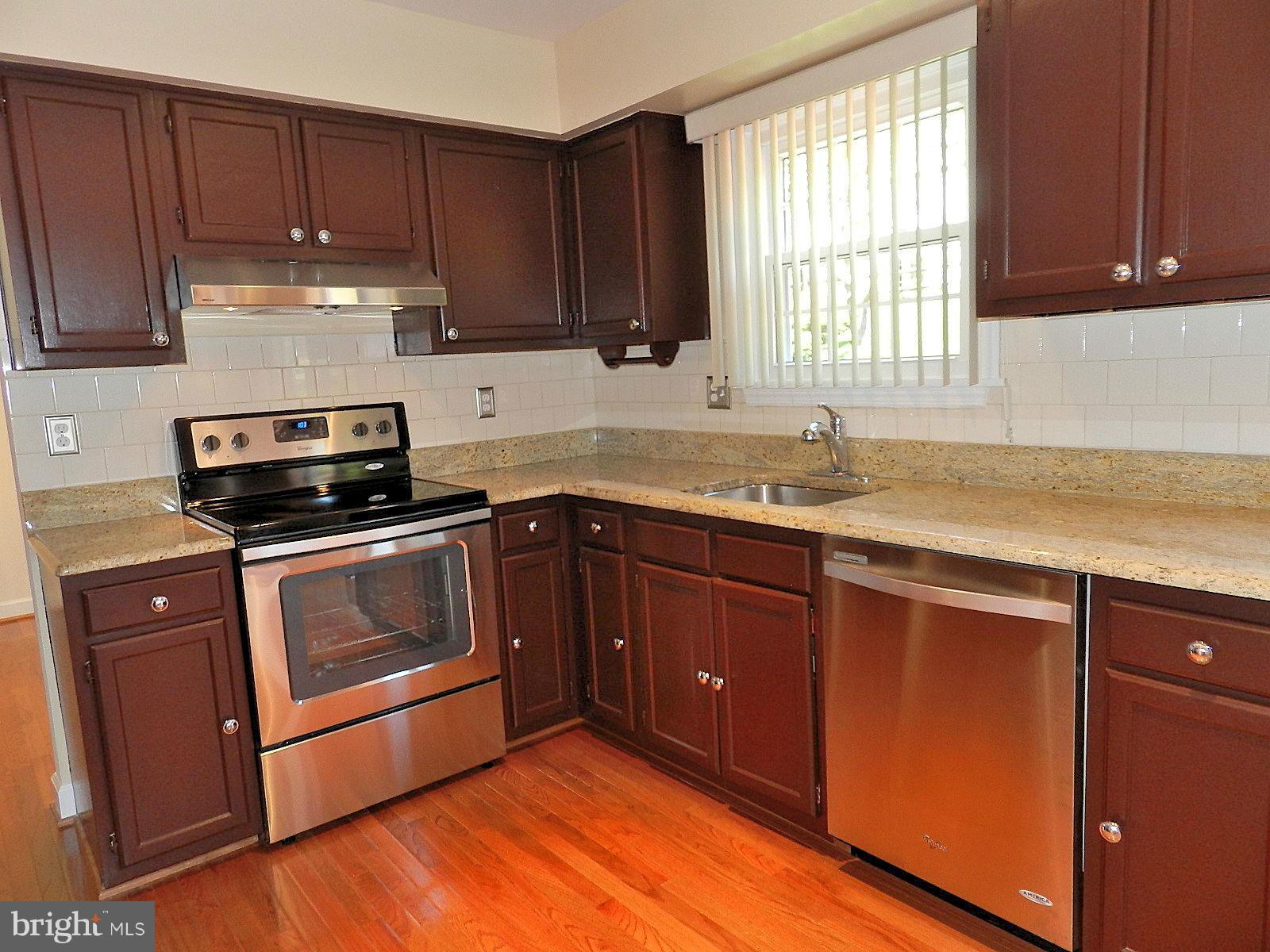 932 Pointer Ridge Drive Gaithersburg, MD 20878 - Photo 10 of 29 a kitchen with a sink stove top oven and cabinets