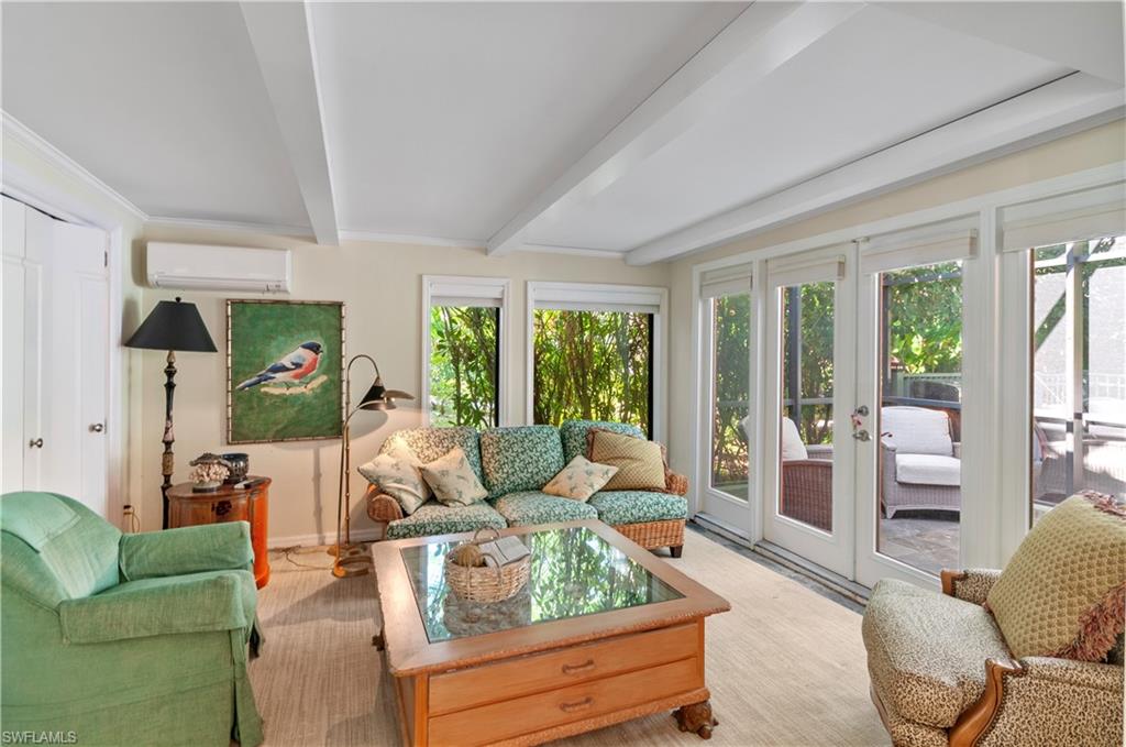 1313 Solana Road, Unit A3 Naples, FL 34103 - Photo 15 of 29 Sunroom / solarium with french doors, beam ceiling, and a wall mounted AC