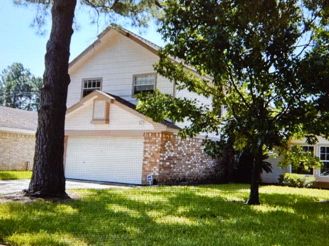 7715 Goldengrove Drive Spring, TX 77379 - Photo 4 of 6 a view of a backyard with a tree