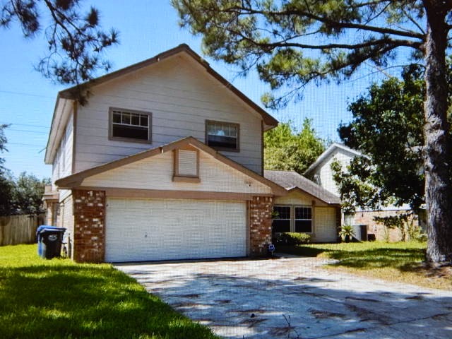 7715 Goldengrove Drive Spring, TX 77379 - Photo 5 of 6 a front view of a house with a yard and garage
