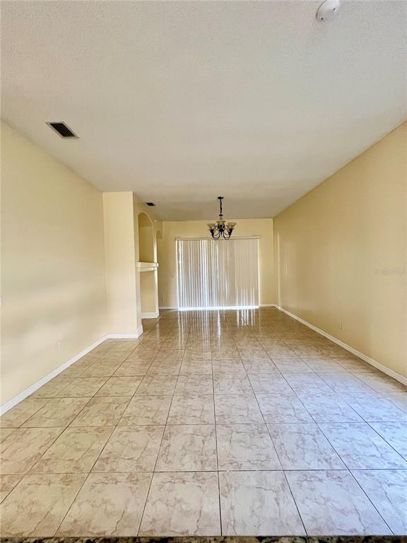 13367 Luxbury Loop Orlando, FL 32837 - Photo 14 of 49 a view of empty room with wooden floor and fan