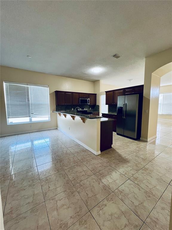 13367 Luxbury Loop Orlando, FL 32837 - Photo 27 of 49 a view of a kitchen with a refrigerator and a sink