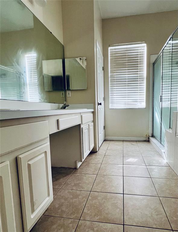 13367 Luxbury Loop Orlando, FL 32837 - Photo 34 of 49 a spacious bathroom with a vanity and a mirror