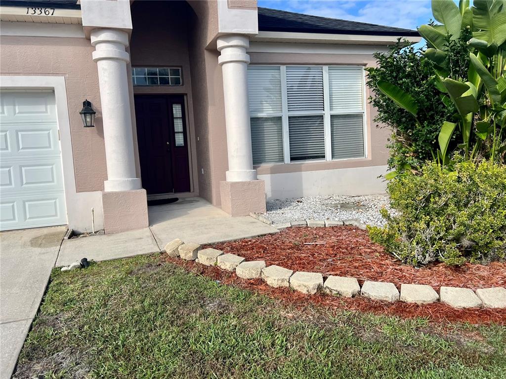 13367 Luxbury Loop Orlando, FL 32837 - Photo 6 of 49 a front view of a house with a yard