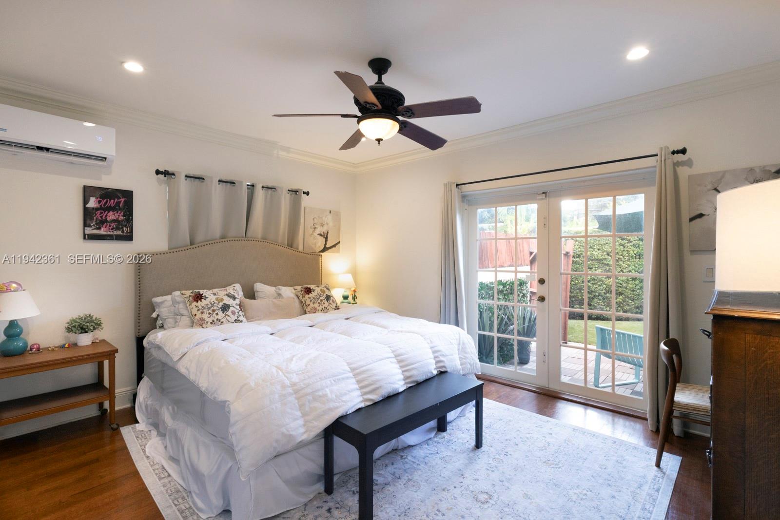 360 Southwest 28th Road Miami, FL 33129 - Photo 17 of 41 a bedroom with a bed and a chandelier
