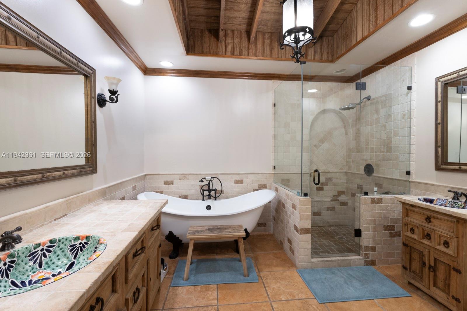 360 Southwest 28th Road Miami, FL 33129 - Photo 18 of 31 a spacious bathroom with a double vanity sink a mirror and a bathtub