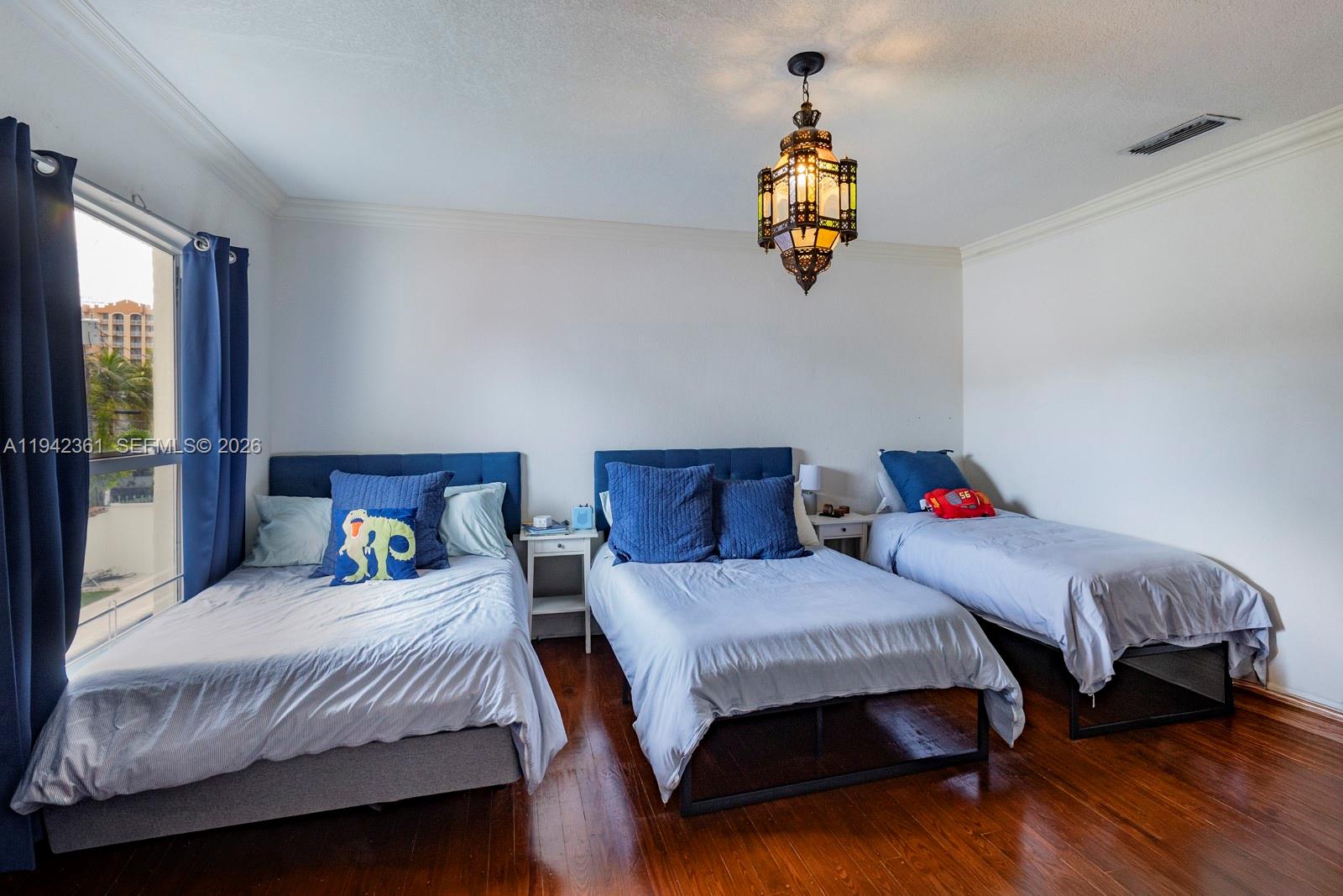 360 Southwest 28th Road Miami, FL 33129 - Photo 20 of 31 a bedroom with a bed and a chandelier