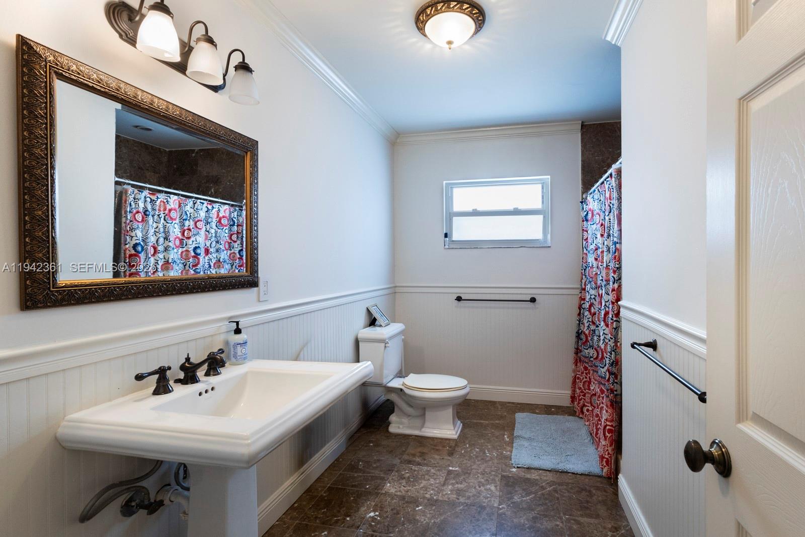 360 Southwest 28th Road Miami, FL 33129 - Photo 21 of 31 a bathroom with a sink a toilet and mirror