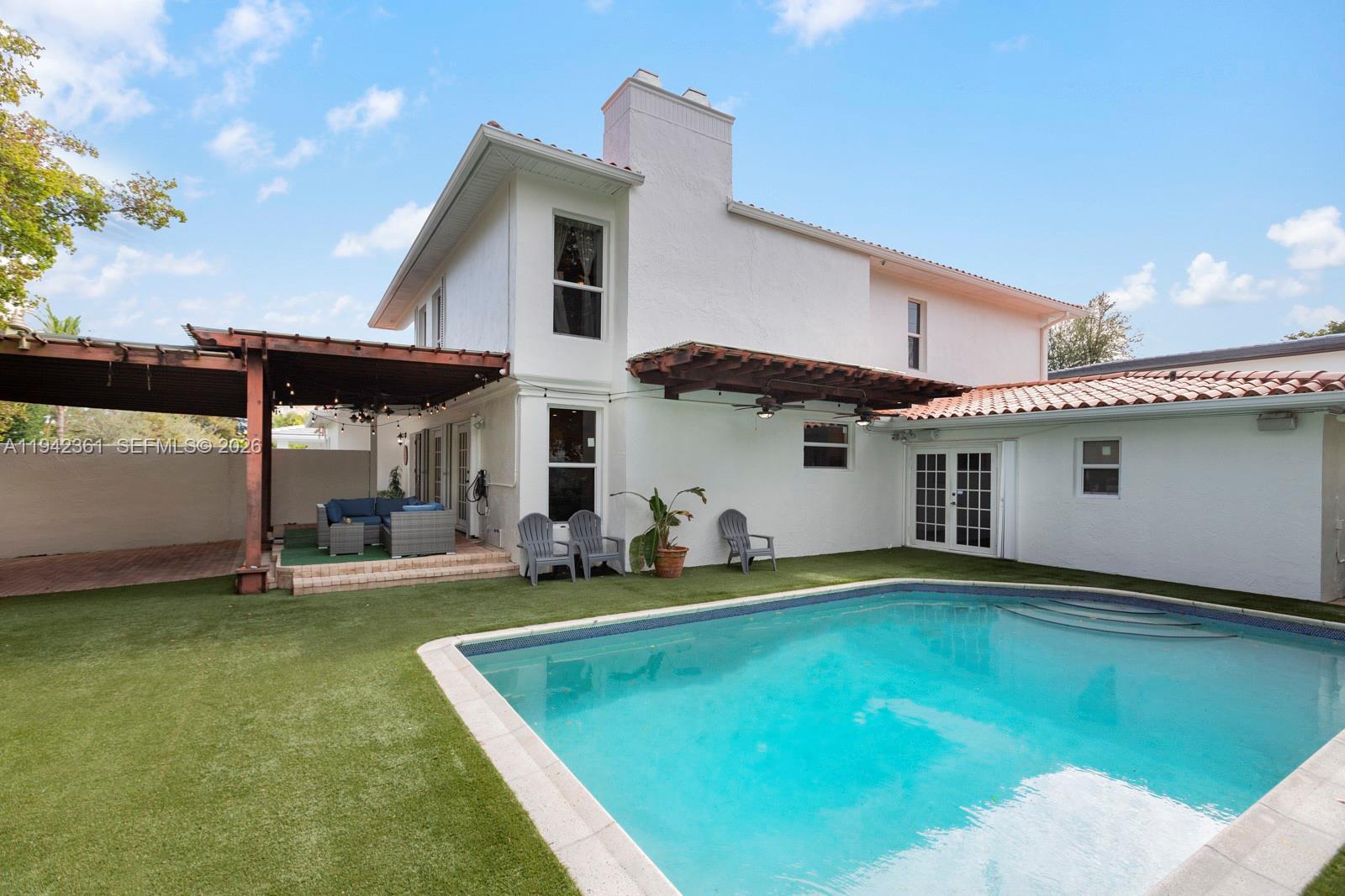 360 Southwest 28th Road Miami, FL 33129 - Photo 22 of 31 a view of a house with swimming pool and porch