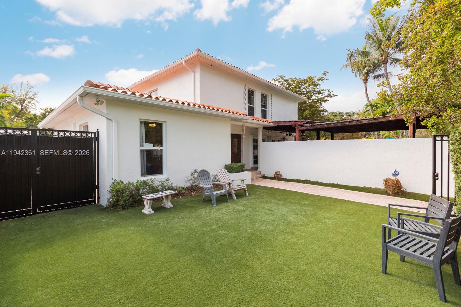 360 Southwest 28th Road Miami, FL 33129 - Photo 25 of 31 a backyard of a house with table and chairs