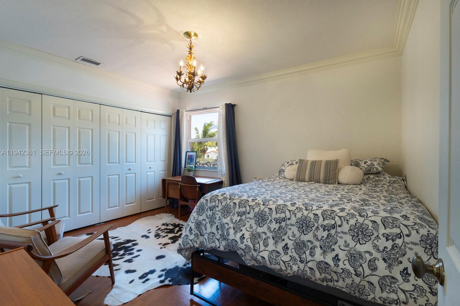 360 Southwest 28th Road Miami, FL 33129 - Photo 26 of 41 a bedroom with a bed and a chandelier