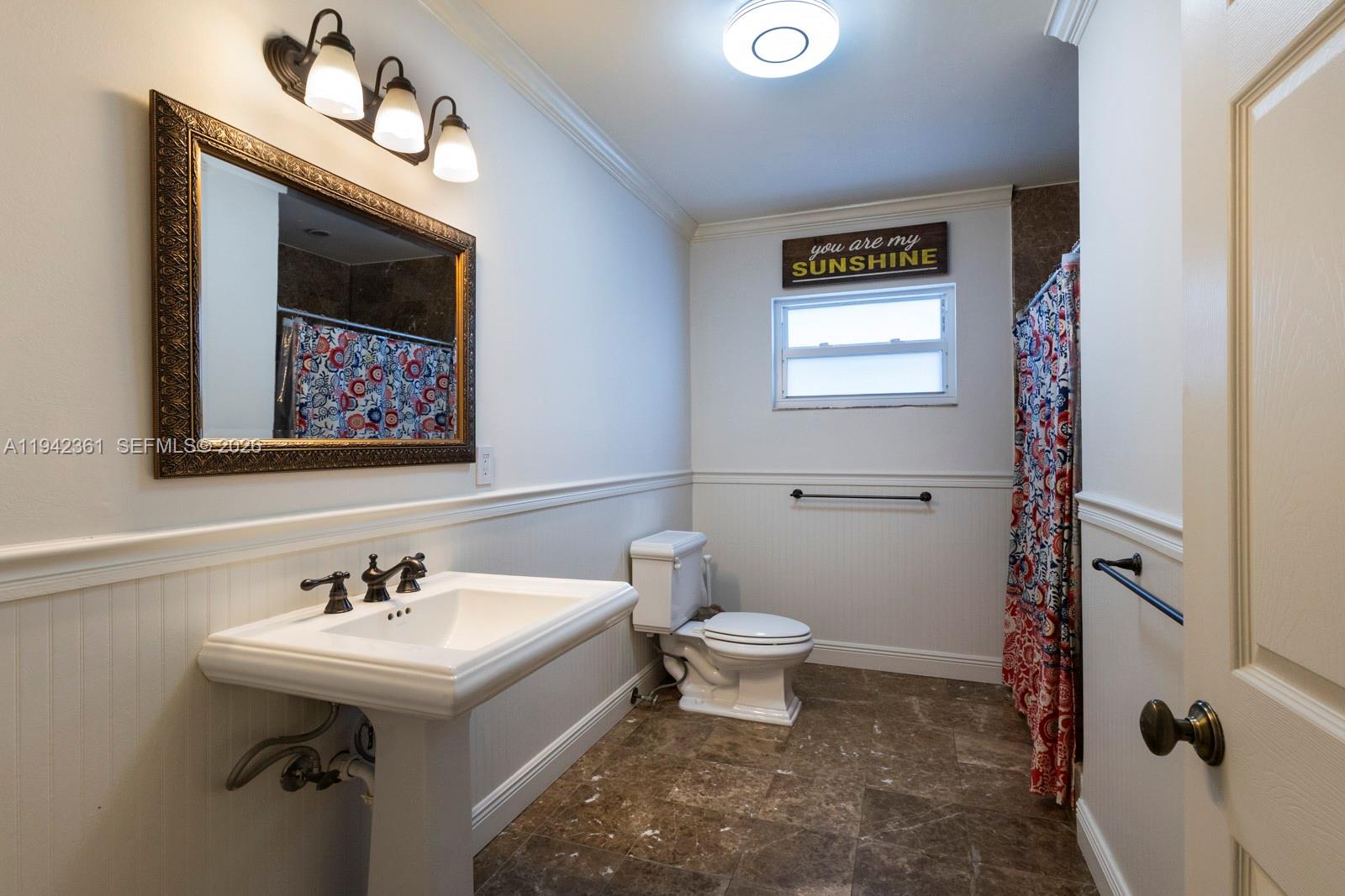 360 Southwest 28th Road Miami, FL 33129 - Photo 28 of 41 a bathroom with a sink mirror and a toilet