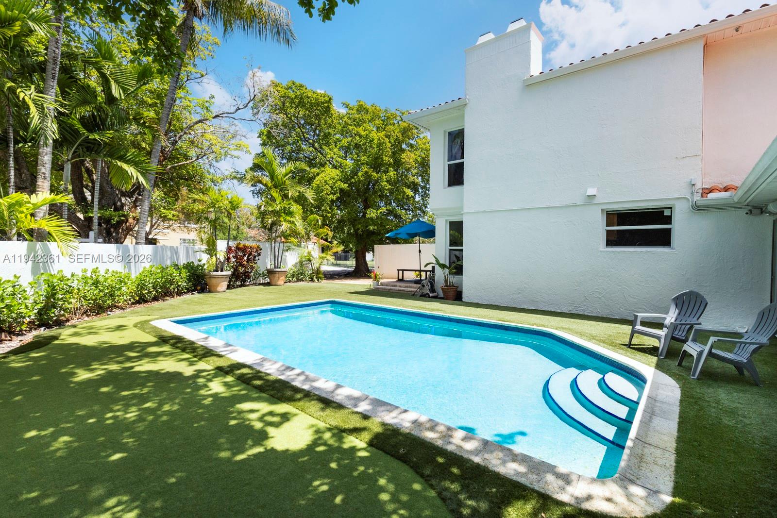 360 Southwest 28th Road Miami, FL 33129 - Photo 30 of 41 a swimming pool with outdoor seating and yard