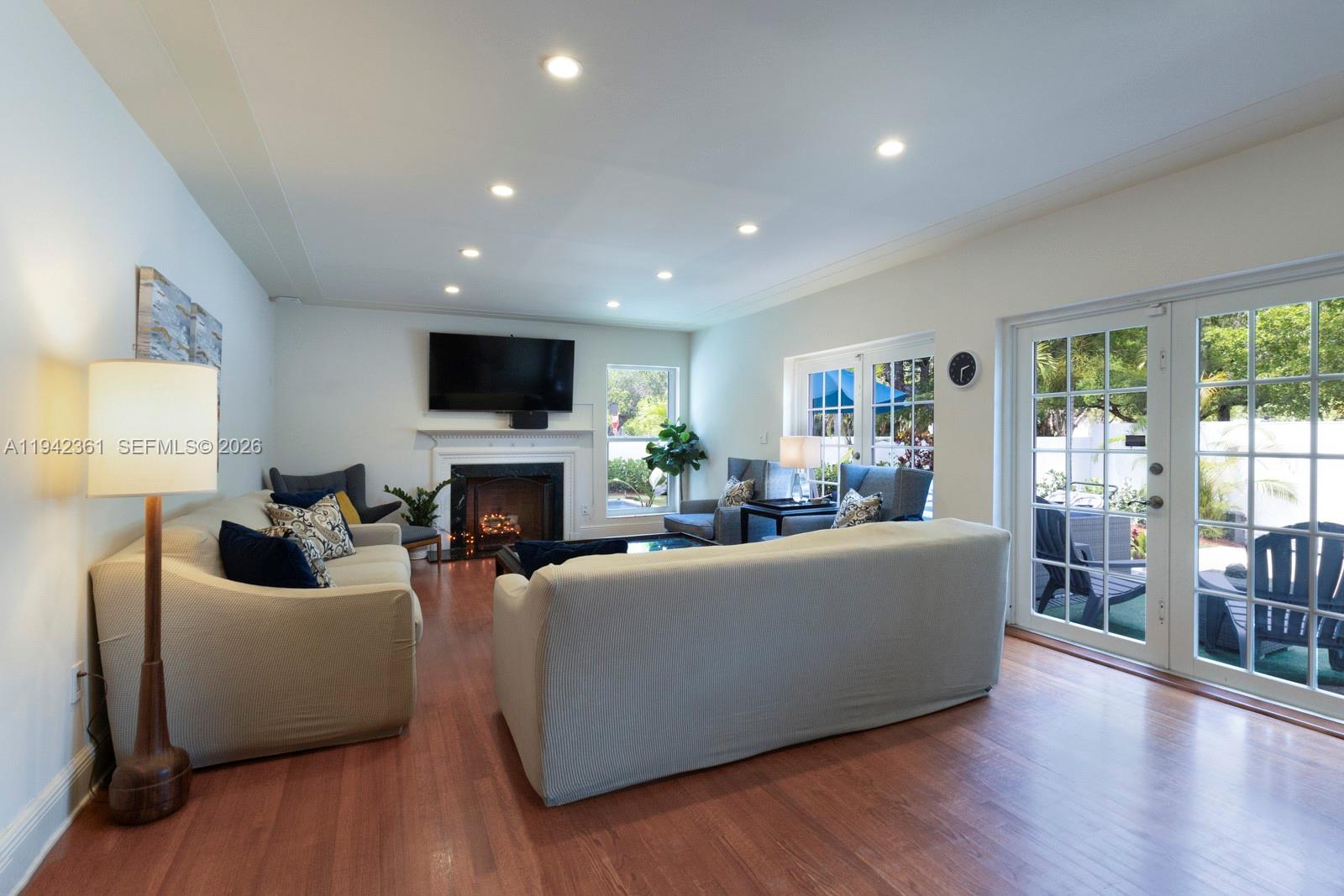 360 Southwest 28th Road Miami, FL 33129 - Photo 7 of 41 a living room with furniture a fireplace and a flat screen tv
