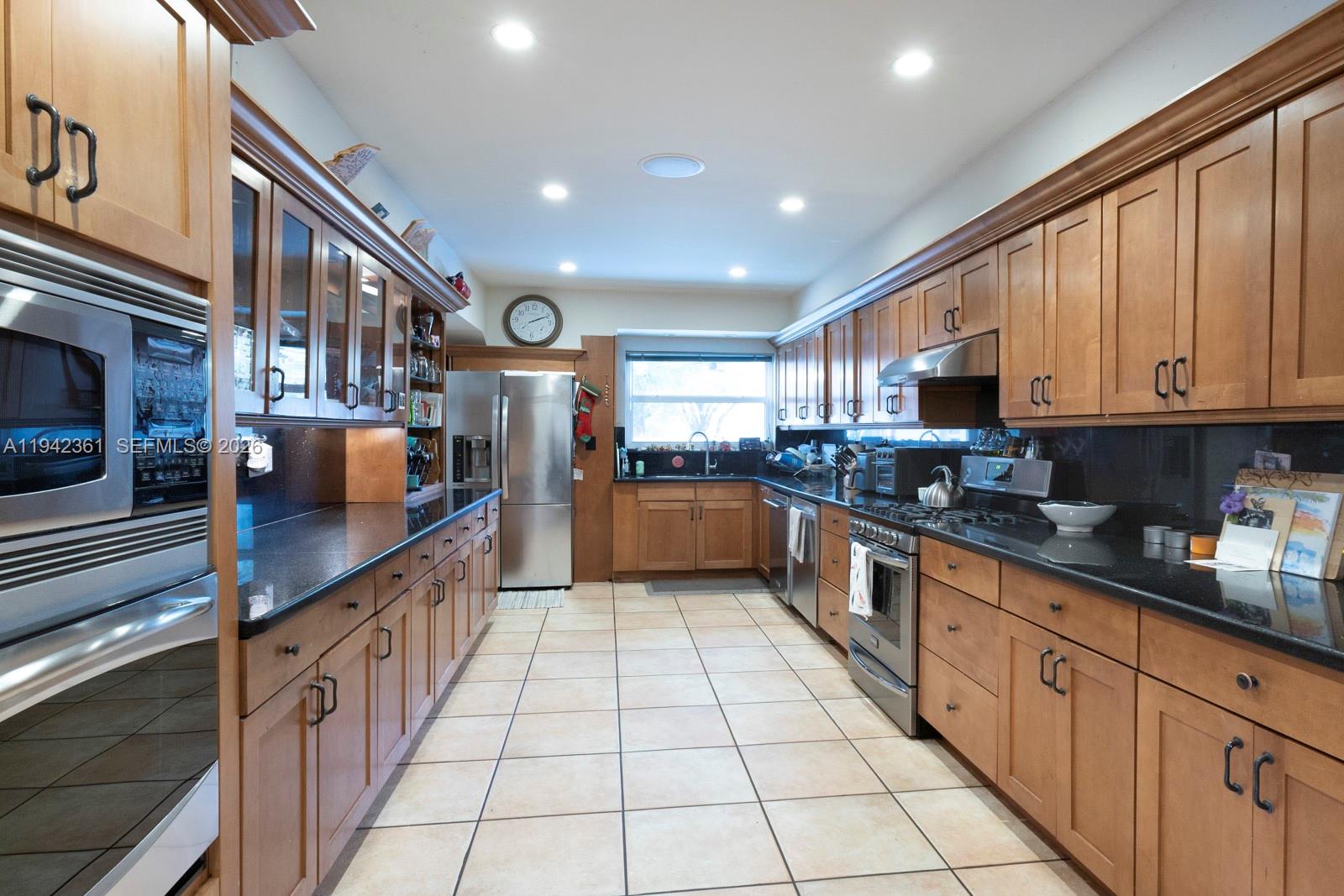 360 Southwest 28th Road Miami, FL 33129 - Photo 8 of 31 a large kitchen with stainless steel appliances granite countertop a large counter top and a stove top oven