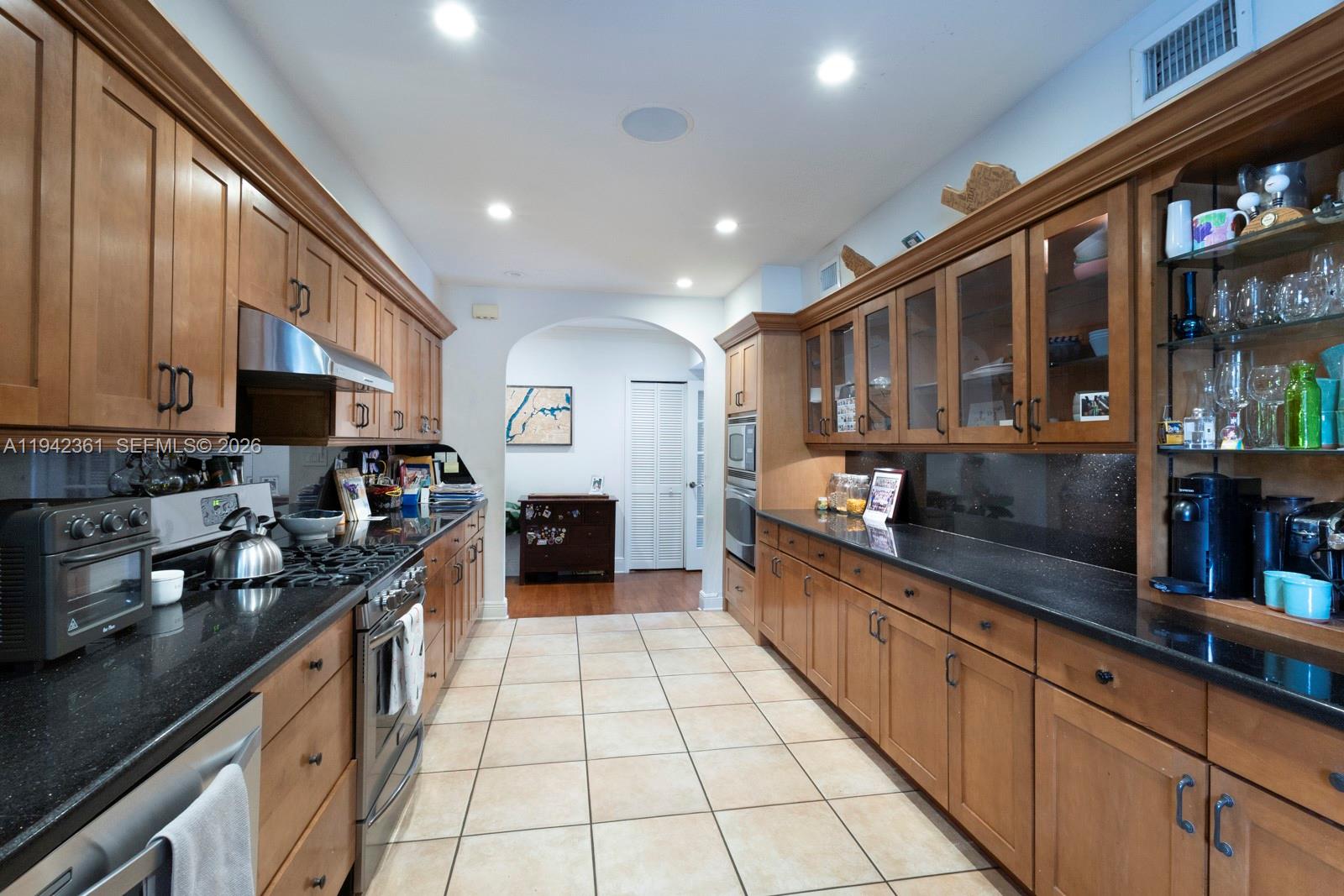 360 Southwest 28th Road Miami, FL 33129 - Photo 9 of 31 a kitchen with stainless steel appliances granite countertop counter space a sink and cabinets
