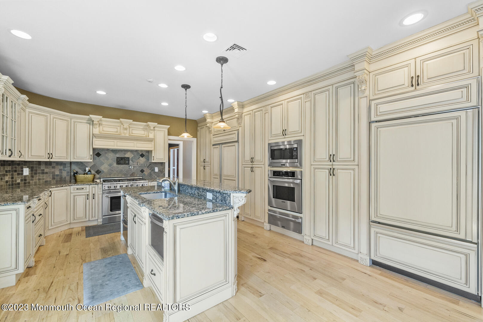 8 Applegate Terrace Manalapan, NJ 07726 - Photo 14 of 36 a kitchen with stainless steel appliances kitchen island granite countertop a refrigerator and cabinets