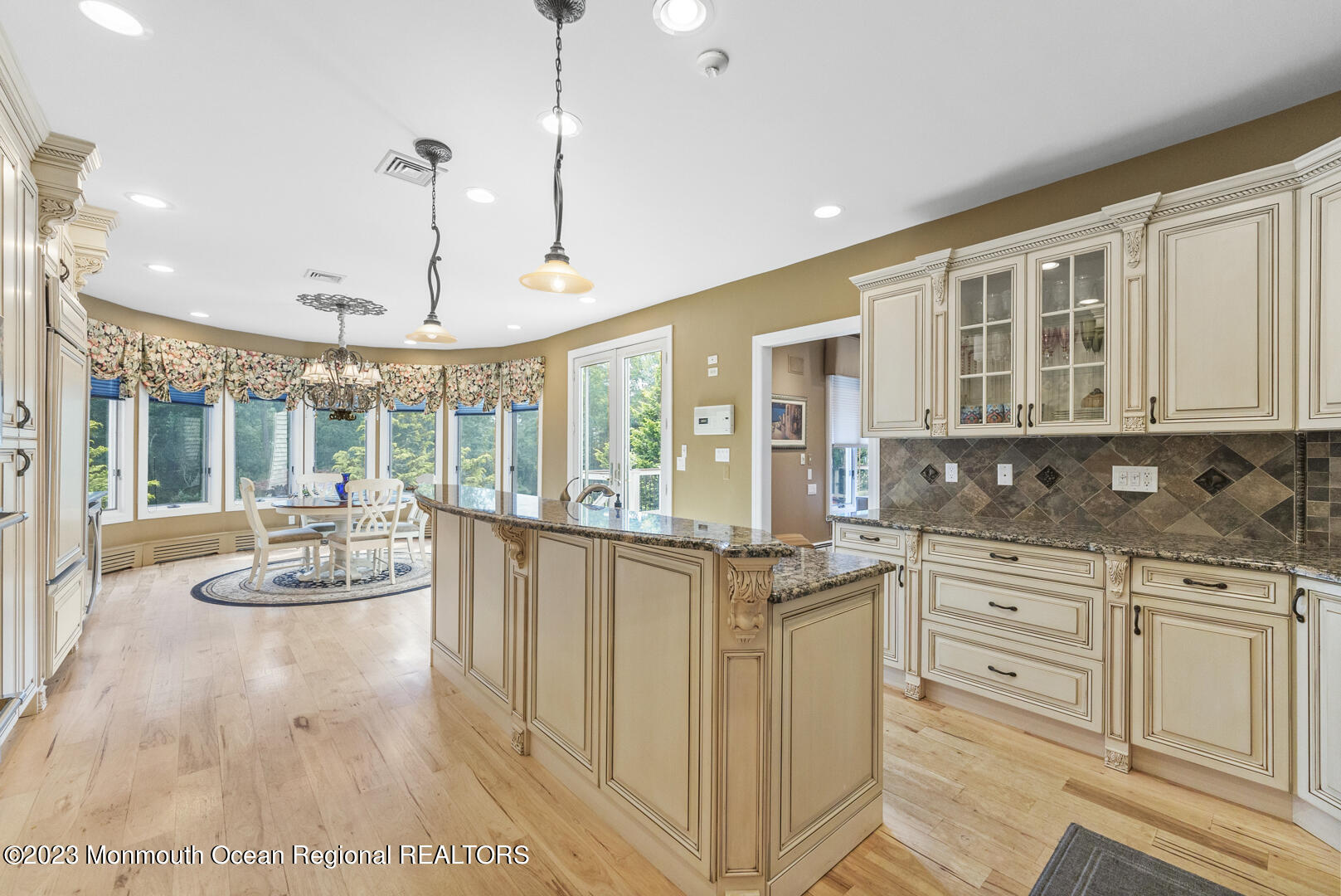 8 Applegate Terrace Manalapan, NJ 07726 - Photo 15 of 36 a open kitchen with white cabinets and chandelier