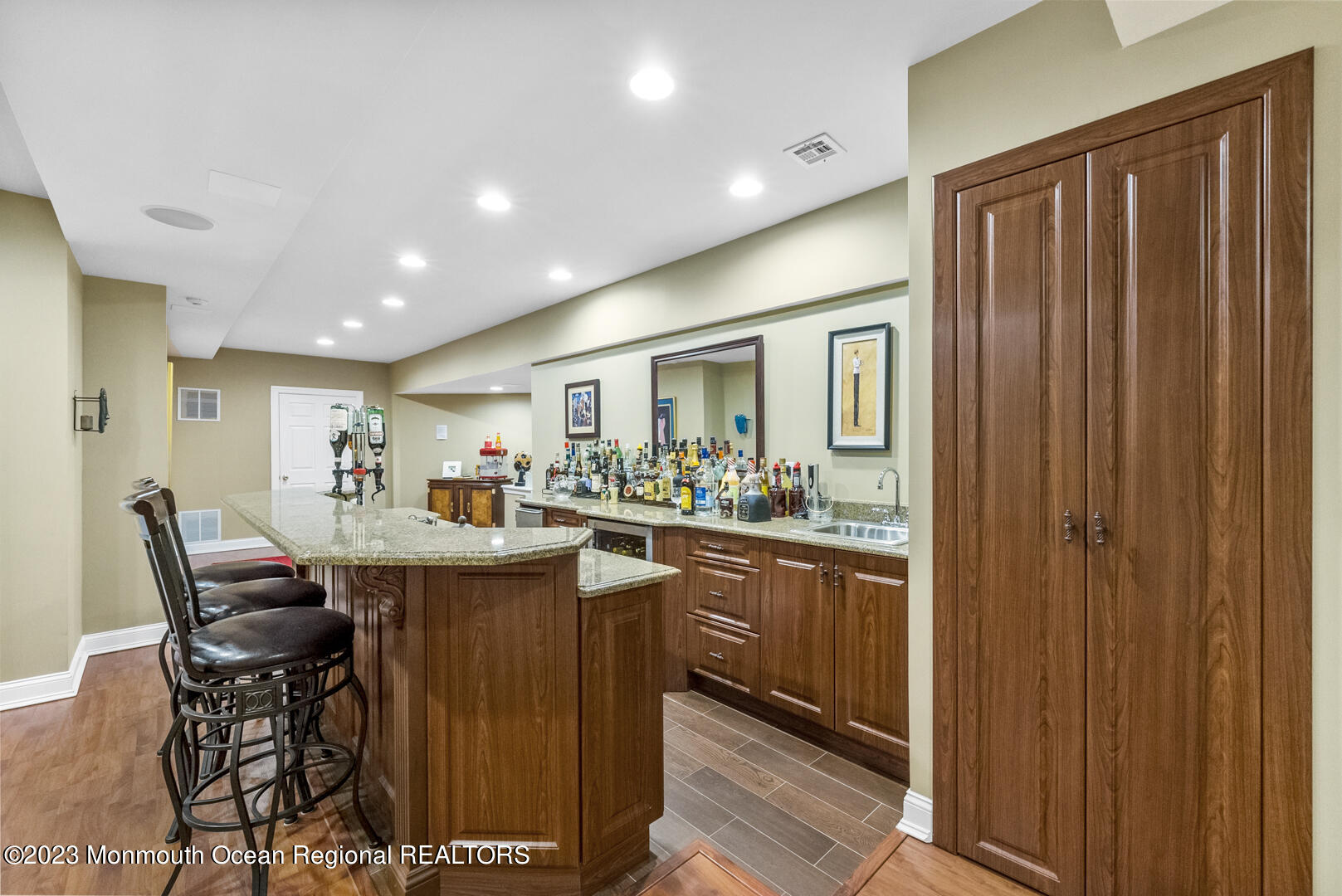 8 Applegate Terrace Manalapan, NJ 07726 - Photo 23 of 36 a kitchen with kitchen island granite countertop wooden cabinets and stainless steel appliances