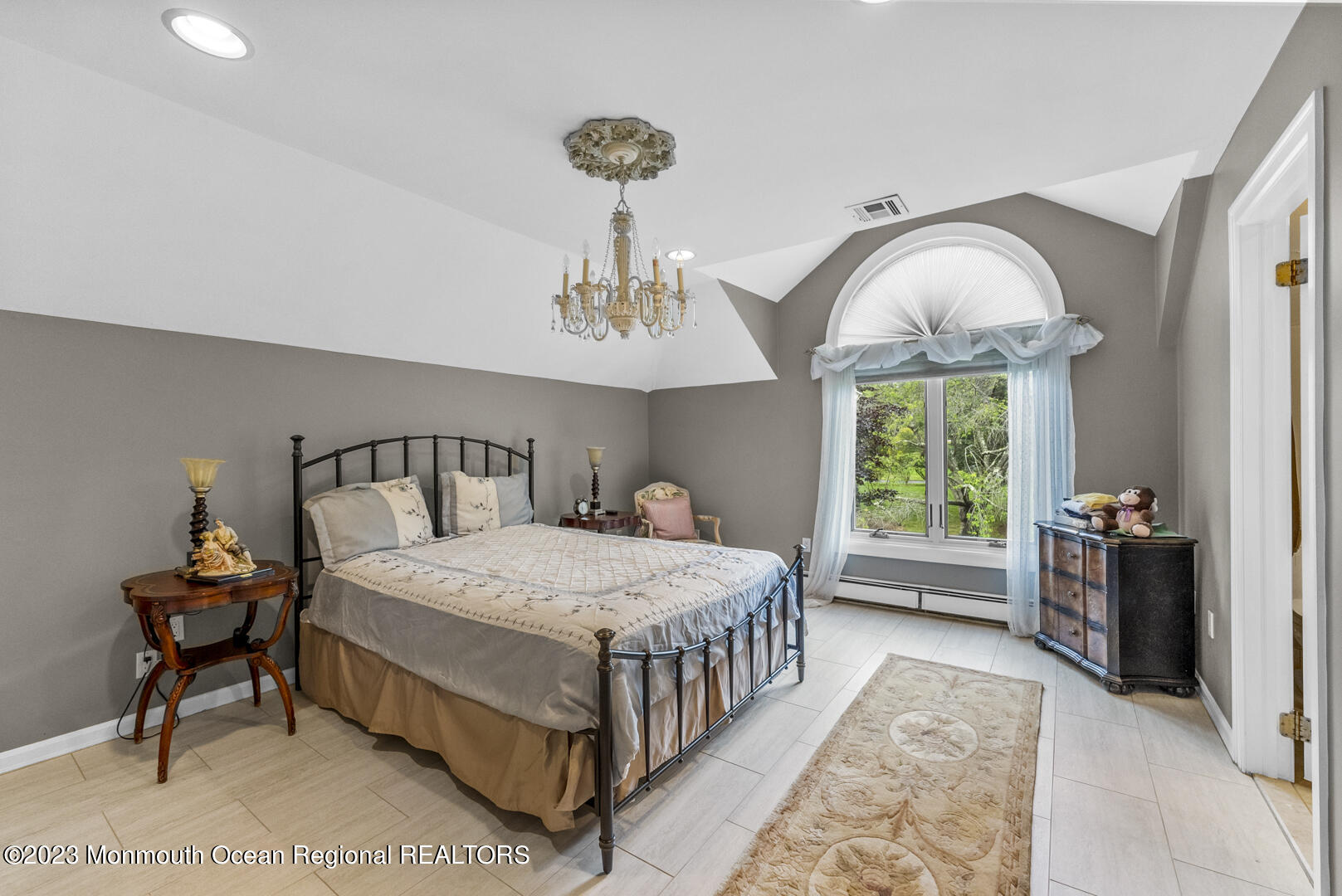8 Applegate Terrace Manalapan, NJ 07726 - Photo 30 of 36 a bedroom with a bed and a chandelier