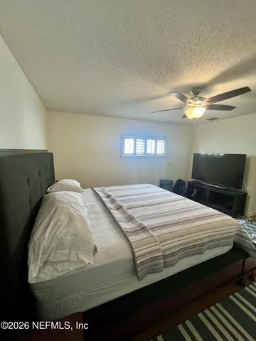 a bedroom with bed and window