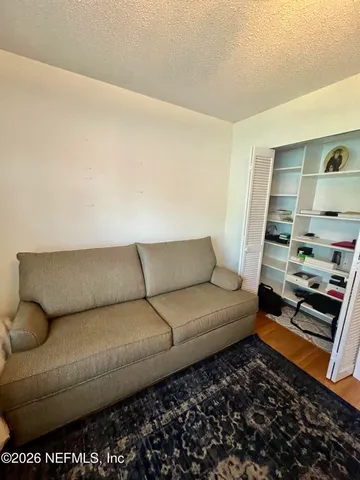 a living room with furniture rug and window