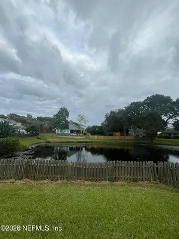 a view of a backyard with table and chairs and potted plants