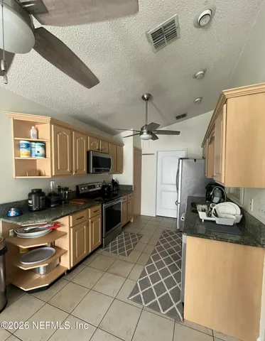 a view of a dining table and chairs in the kitchen