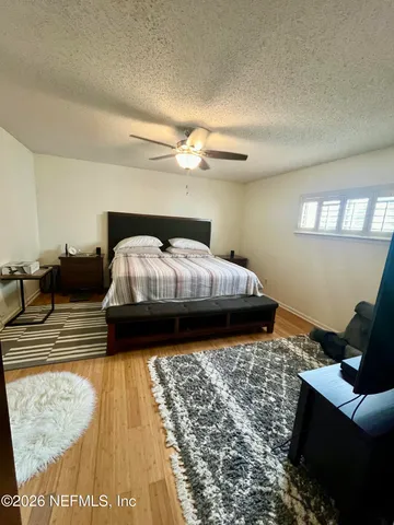 a living room with a large window and furniture