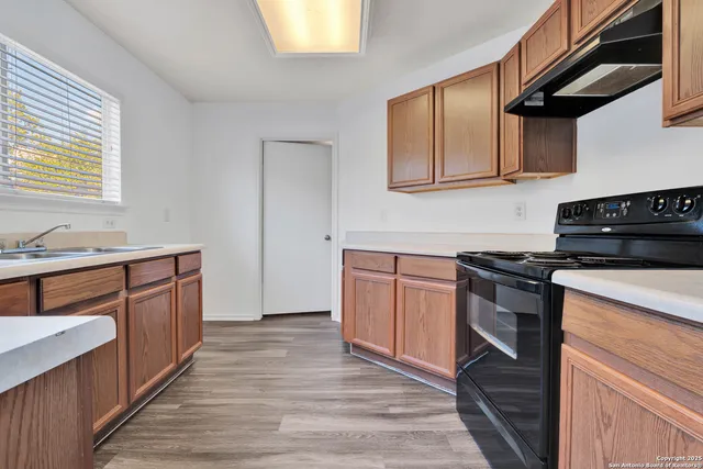 a kitchen with stainless steel appliances granite countertop a stove and a sink