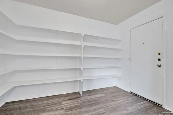 a view of walk in closet with empty racks