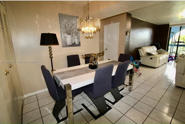 a view of a dining room with furniture and chandelier
