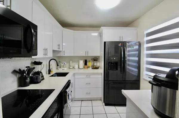 a kitchen with a sink appliances and cabinets